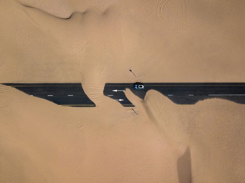 Aerial view of a road through desert sand